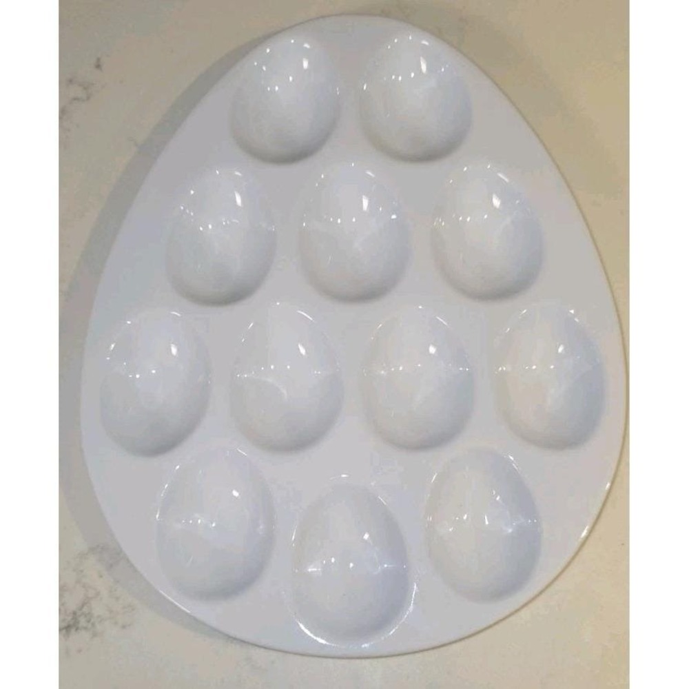 Sur La Table egg-shaped ceramic tray features 12 indentations designed...